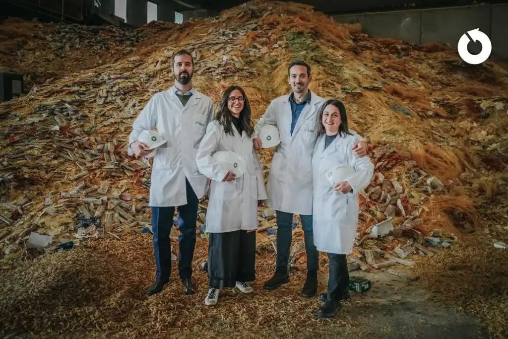 Pictured is the Sfridoo team, wearing white coats , inside a factory filled with production waste
